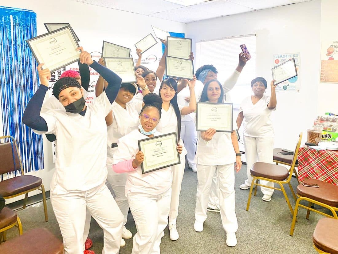 nCareerTek graduates celebrating with their certificates